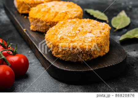 Raw salmon burger patties, on black dark stone table background 86820876