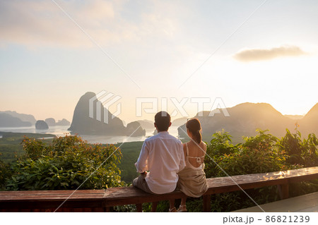 Happy couple traveler enjoy Phang Nga bay view point, Tourists relaxing at Samet Nang She, near Phuket in Southern Thailand. Southeast Asia travel, trip, love, together and summer vacation concept 86821239