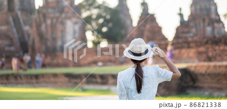 Tourist Woman in white dress visiting to ancient stupa in Wat Chaiwatthanaram temple in Ayutthaya Historical Park, summer, Asia and Thailand travel concept 86821338