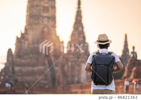 Tourist Man with backpack visiting to ancient stupa in Wat Chaiwatthanaram temple in Ayutthaya Historical Park, summer, solo, Asia and Thailand travel concept 86821363