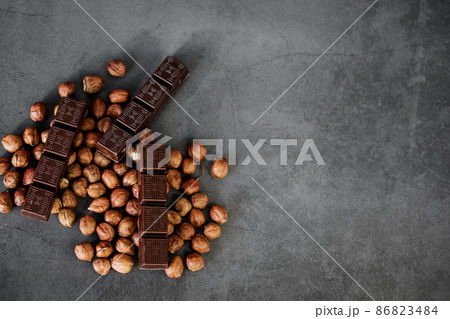 dark chocolate with hazelnuts dark chocolate with hazelnuts 86823484