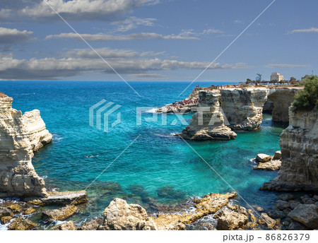 Melendugno,province of Lecce, Puglia, Italy. August 2021. The stacks of Sant'Andrea are a point of naturalistic attraction Melendugno,province of Lecce, Puglia, Italy. August 2021. The stacks of Sant'Andrea are a point of naturalistic attraction 86826379