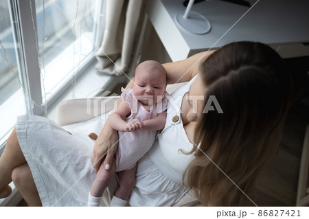 young beautiful woman kisses her little cute daughter. family portrait 86827421