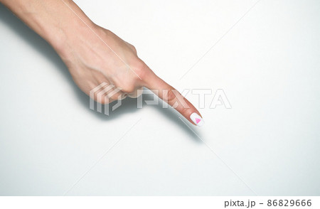Pointing gesture. Female hand shows index finger with rose triangle manicure. Symbol of lesbian, gay, bisexual, transgender and queer pride isolated on white background. 86829666
