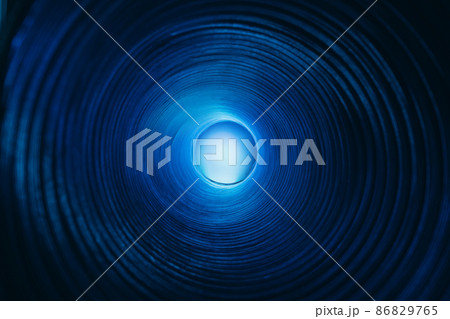 Blur glow background. Galaxy portal. Moonlight radiance. Defocused neon blue color lunar light sphere in ridged swirl texture tunnel on dark black. Blur glow background. Galaxy portal. Moonlight radiance. Defocused neon blue color lunar light sphere in ridged swirl texture tunnel on dark black. 86829765