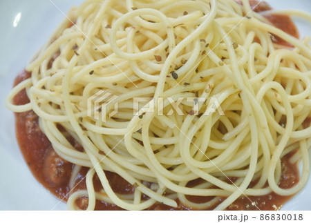 spaghetti dressing fried chop pork and slice tomato in ketchup sauce on plate spaghetti dressing fried chop pork and slice tomato in ketchup sauce on plate 86830018