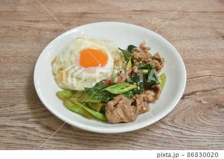 spicy stir fried Chinese kale with pork topping egg on rice spicy stir fried Chinese kale with pork topping egg on rice 86830020