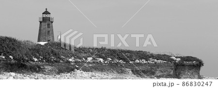 Black and White of the Point Judith Lighthouse above the sand rocks and snad dunes 86830247