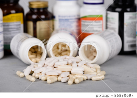 Bottles of vitamins and dietary supplements with pills on table 86830697