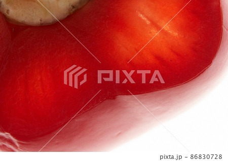 Part of a piece of sweet red bell pepper. Detail of half a red pepper on an isolated white background. High quality photo 86830728