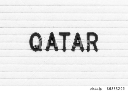 Black color letter in word qatar on white felt board background 86833296