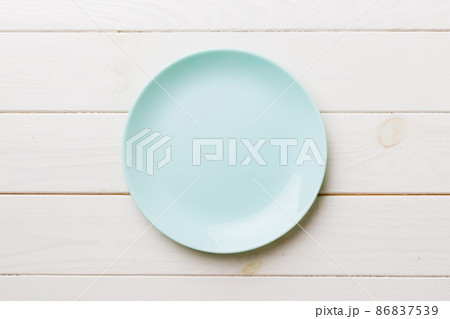 Top view of empty blue plate on wooden background. Empty space for your design 86837539