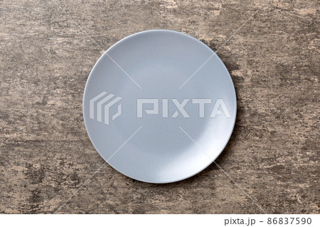 Top view of empty grey plate on cement background. Empty space for your design Top view of empty grey plate on cement background. Empty space for your design 86837590