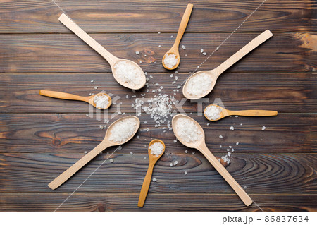 salt on many wooden spoon on wood background. Spoons with different salt 86837634