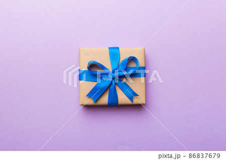 Holiday present box over colored background, top view. Copy space for design 86837679