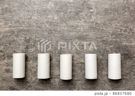 Flat lay composition with empty toilet paper rolls and space for text on color background. Recyclable paper tube with metal plug end made of kraft paper or cardboard 86837680