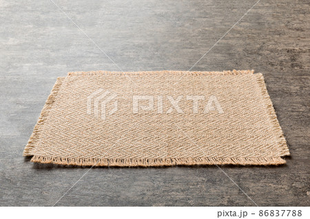 Perspective view of brown tablecloth for food on cement background. Empty space for your design 86837788