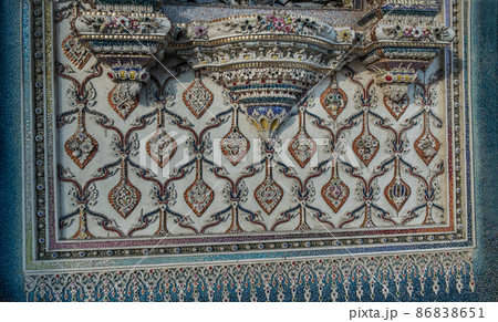 Elaborate sculptures is made of bricks and mortar, decorated with various colored glazed tiles on side exterior wall. 86838651