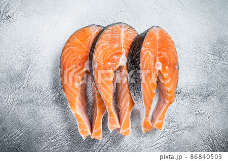 Salmon or trout steaks, raw fish prepared for cooking. White background. Top view 86840503