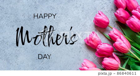 Mother's Day Concept. Fresh tulip flowers on a gray concrete background. Bright spring background. Mother's Day Concept. Fresh tulip flowers on a gray concrete background. Bright spring background. 86840611