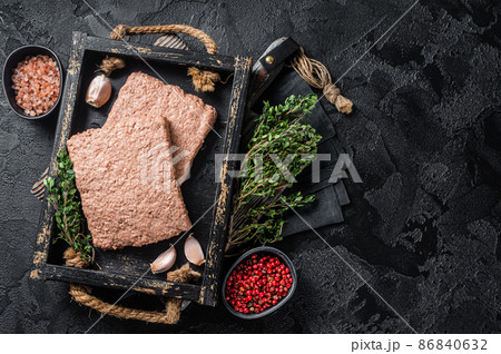 Raw plant based vegan mince meat with herbs. Black background. Top view. Copy space 86840632