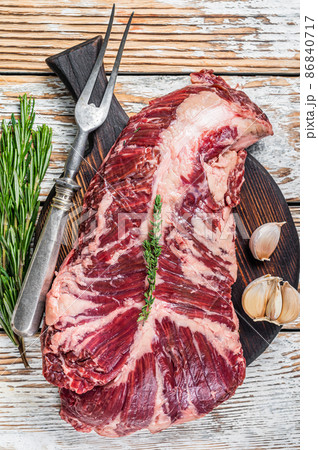 Butchers choice steak Onglet Hanging Tender beef meat on a cutting board. White wooden background. Top View 86840717