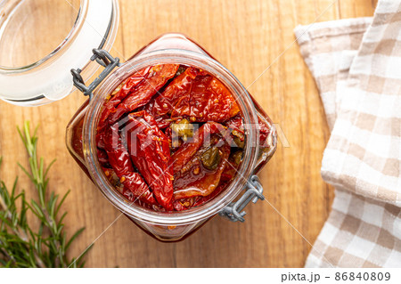 Sun dried tomatoe. Pickled tomatoes in jar. 86840809
