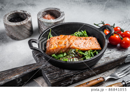 Salmon fillets, grilled steaks in skillet with herbs. White background. Top view 86841055