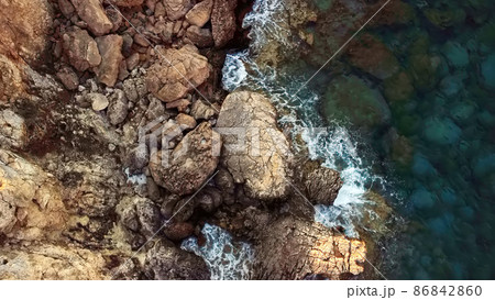 Aerial drone view of the rocky coast and the Mediterranean Sea near the scenic Aphrodite Trail in the Akamas Peninsula National Park, Cyprus. Aerial drone view of the rocky coast and the Mediterranean Sea near the scenic Aphrodite Trail in the Akamas Peninsula National Park, Cyprus. 86842860