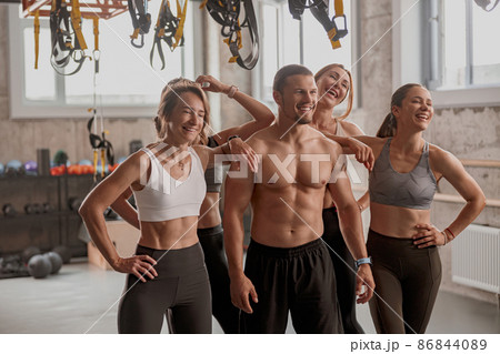 Personal trainer with his clients in gym Personal trainer with his clients in gym 86844089