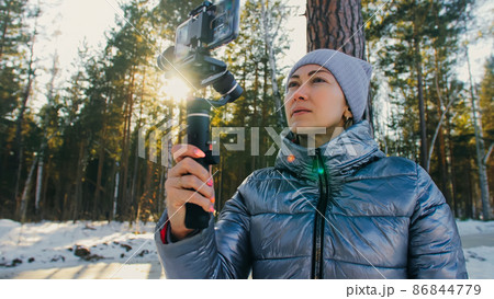 Woman Holding On Handheld Film 3-axis Gimbal Stabilization Devic Woman Holding On Handheld Film 3-axis Gimbal Stabilization Devic 86844779