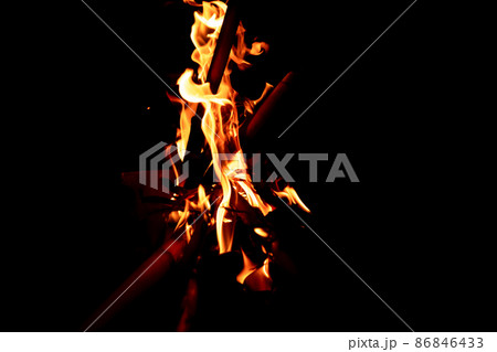 Beautiful formation of fire created by burning some dry reeds forming spectacular and bright flames in the dark of the night. Concept of beauty and destruction. 86846433
