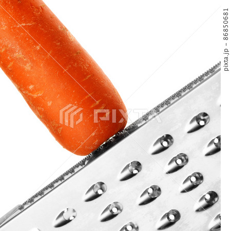 Ripe carrot rubbing on a grater 86850681