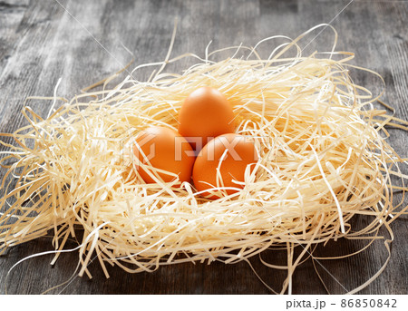 Chicken eggs in a nest Chicken eggs in a nest 86850842