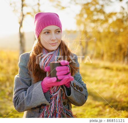 Young woman enjoying the fall season. Autumn outdoor portrait 86851121