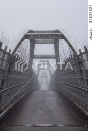 Pedestrian bridge over the Trans-Canada Highway 1 during a winter foggy morning. Pedestrian bridge over the Trans-Canada Highway 1 during a winter foggy morning. 86852627