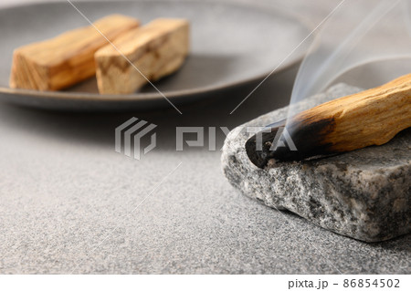 Palo Santo stick incense burning for aromatherapy. Palo Santo stick incense burning for aromatherapy. 86854502