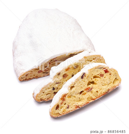 Sliced Traditional Christmas stollen cake with marzipan and dried fruit isolated on white background Sliced Traditional Christmas stollen cake with marzipan and dried fruit isolated on white background 86856485