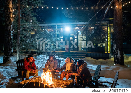 Friends spending winter vacation in the country house Friends spending winter vacation in the country house 86857459