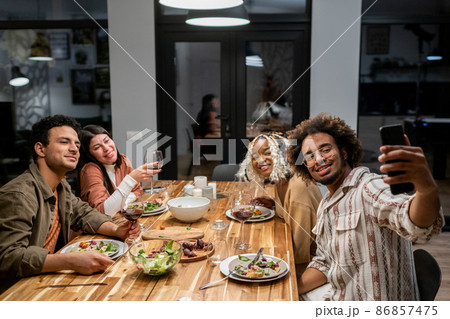Friends making selfie portrait at dinner party Friends making selfie portrait at dinner party 86857475