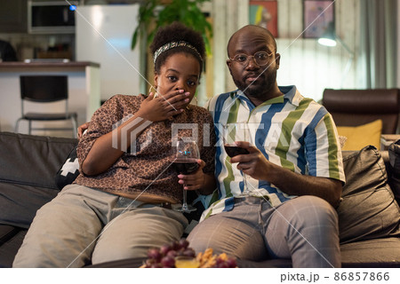 Couple enjoying the movie and red wine Couple enjoying the movie and red wine 86857866
