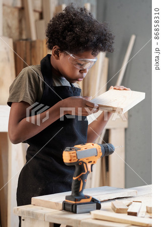 Little Boy Building in Workshop 86858310