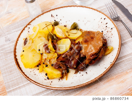 Portion of duck confit on table 86860734