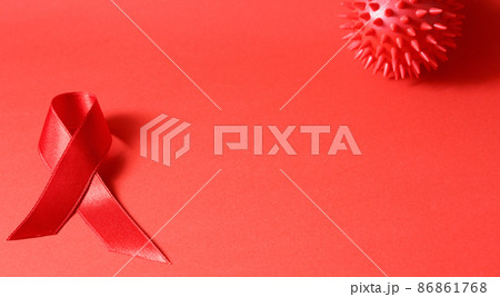 Sign of cancer red ribbon on the table. Sign of cancer red ribbon on the table. 86861768