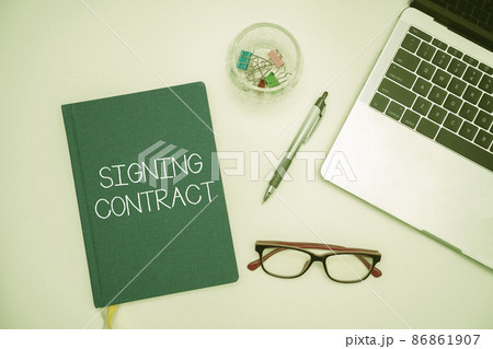 Text caption presenting Signing Contract. Business idea the parties signing the document agree to the terms Office Supplies Over Desk With Keyboard And Glasses And Coffee Cup For Working Text caption presenting Signing Contract. Business idea the parties signing the document agree to the terms Office Supplies Over Desk With Keyboard And Glasses And Coffee Cup For Working 86861907