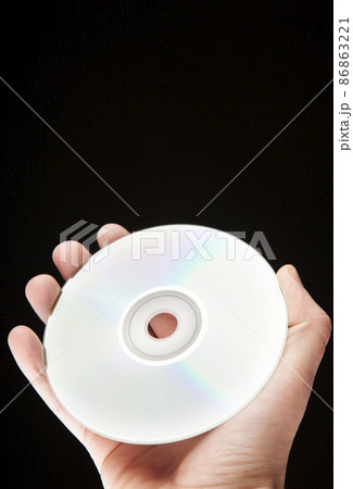 image of cd disk hand dark background  86863221