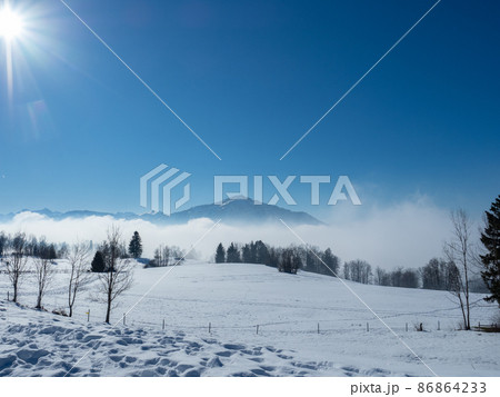 View from a snow covered meadow towards Rigi, a famous mountain in Switzerland 86864233