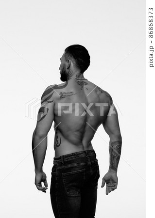 Muscular shirtless tattooed guy in studio Muscular shirtless tattooed guy in studio 86868373
