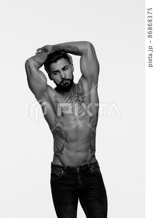 Muscular shirtless tattooed guy in studio Muscular shirtless tattooed guy in studio 86868375