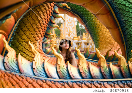 Happy asian woman smiling in colorful serpent statue at Wat Phra That Nong Bua temple 86870918